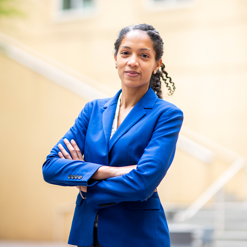 Felicia Lamothe, Full-time MBA ‘23, stands confidently outside in a blue business jacket with her arms folded