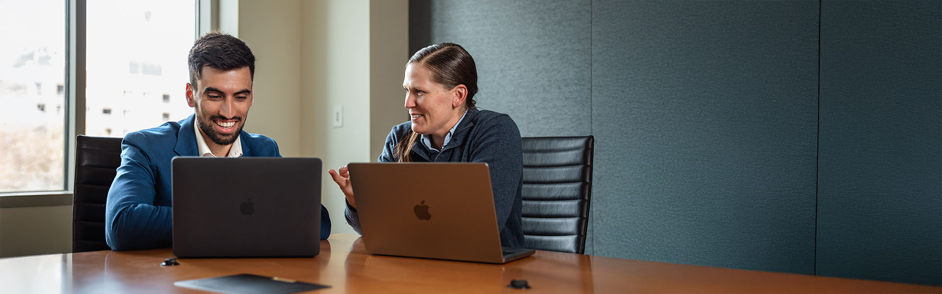 Two student on laptop inside a Scheller breakout room