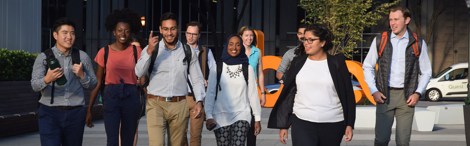 Group of scheller mba students walking together outside coda