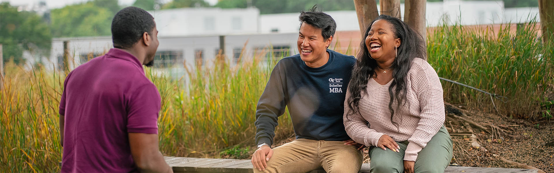 3 students meeting outside, casual clothing