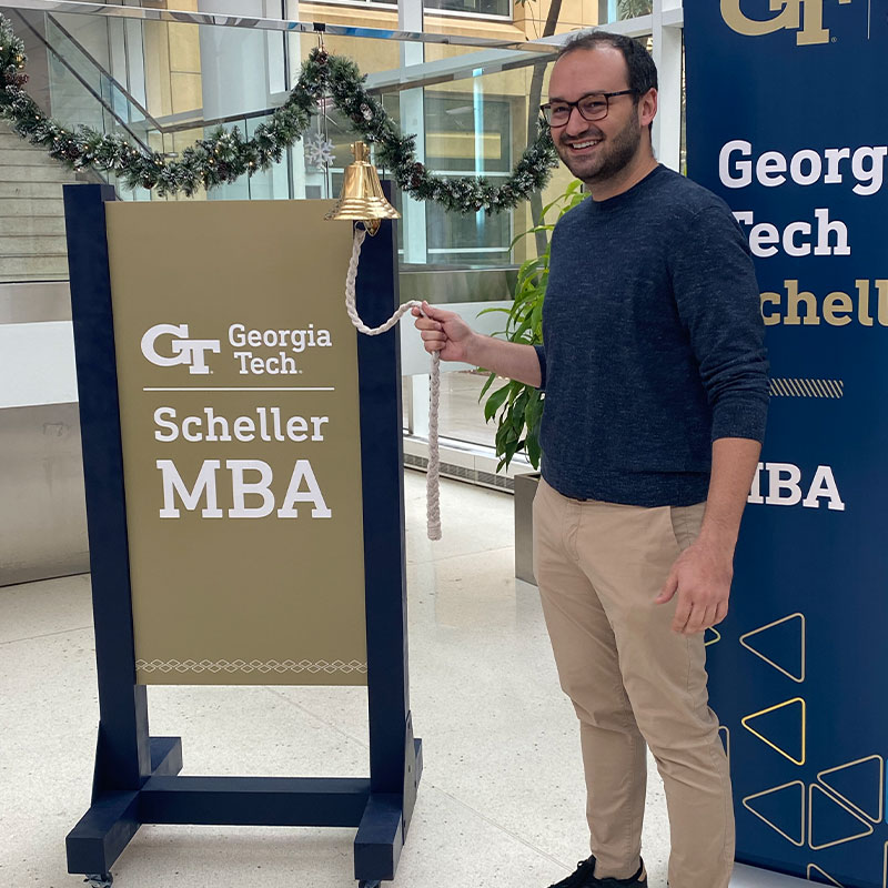 Victor Couri Sabioni rings the bell at the Scheller College of Business to celebrate his new job 