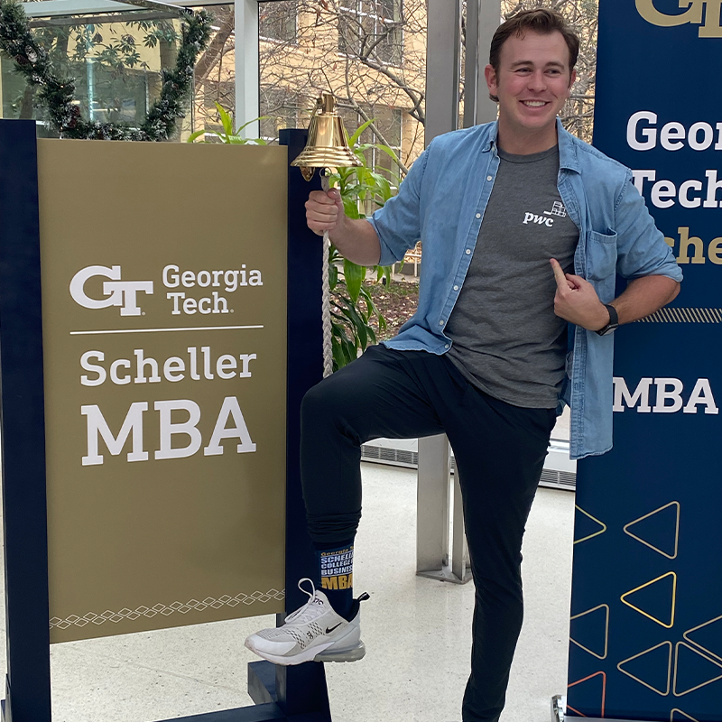 Thomas Landzert rings the bell at the Scheller College of Business to celebrate his new job 