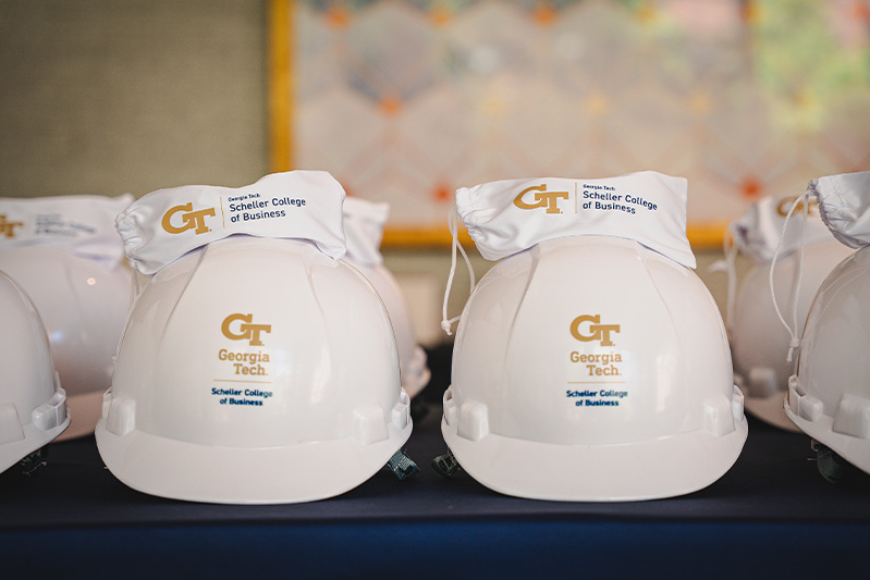 Hard hats are lined up on a table