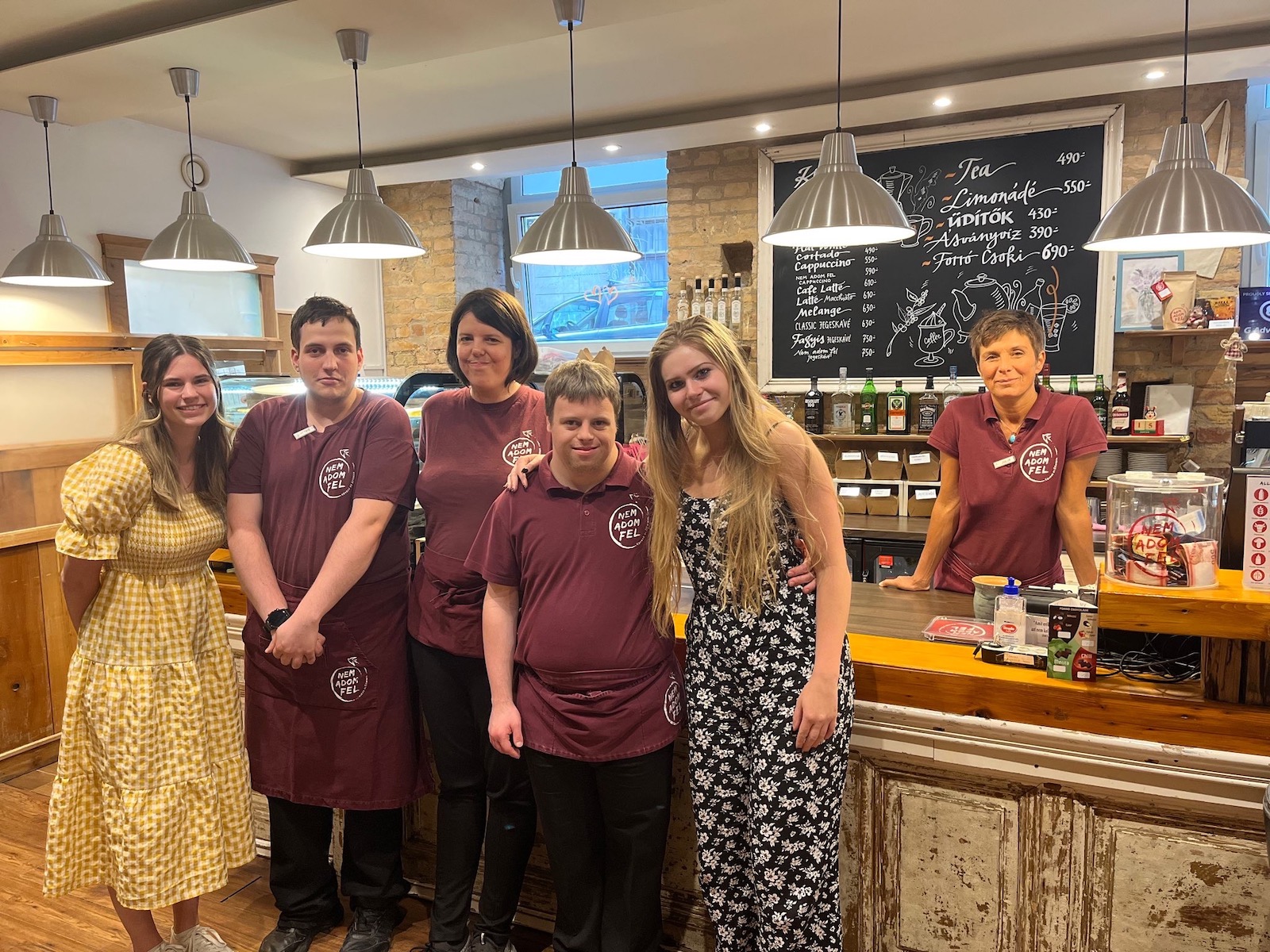 Leadership for Social Good study abroad program students, Katerina Addington (business administration) and Lauren Haggerty (industrial design), with the staff at Nem Adom Fel (“I Don’t Give Up”) Café, a social enterprise in Budapest, Hungary operated by people with disabilities.