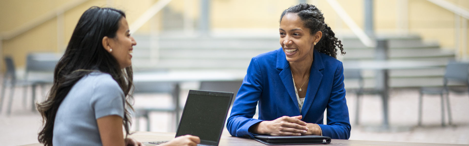 Two women sitting around a laptop