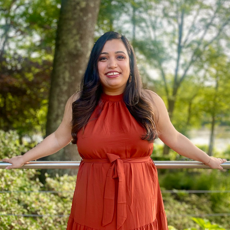 A woman smiles at the camera