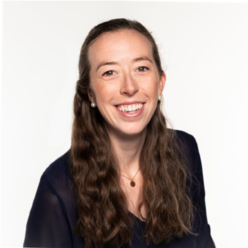 A woman smiles dressed in black