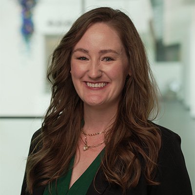 Kelsey Terreson smiles in a green suit jacket
