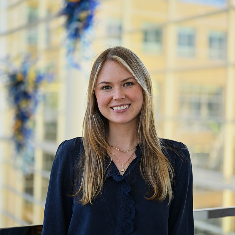 Lauren Dasher smiles for a headshot photo in the Scheller College of Business atrium