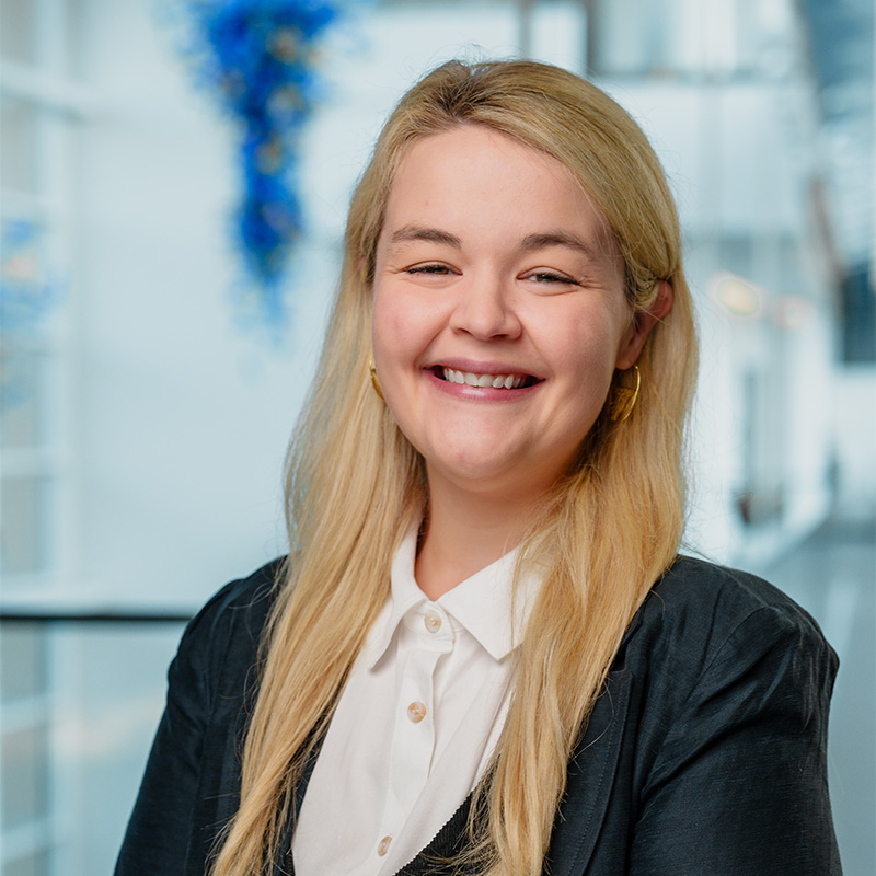 Megan Phillips smiles in the Scheller building atrium