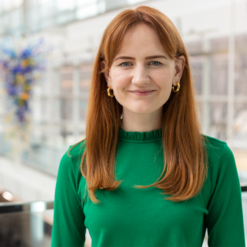 Grace Stewart, Full-time MBA '22, dressed in green.