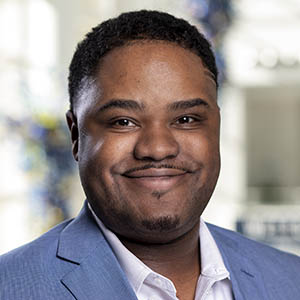 Jacoby Golden, Evening MBA '23 in a blue business suit