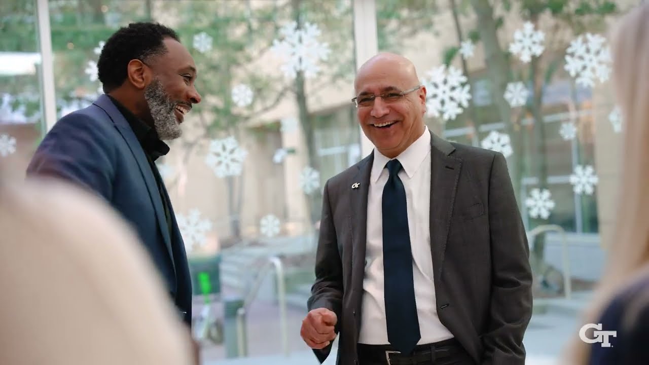 Photo of a group of staff and faculty speaking with Dean Anuj Mehrotra