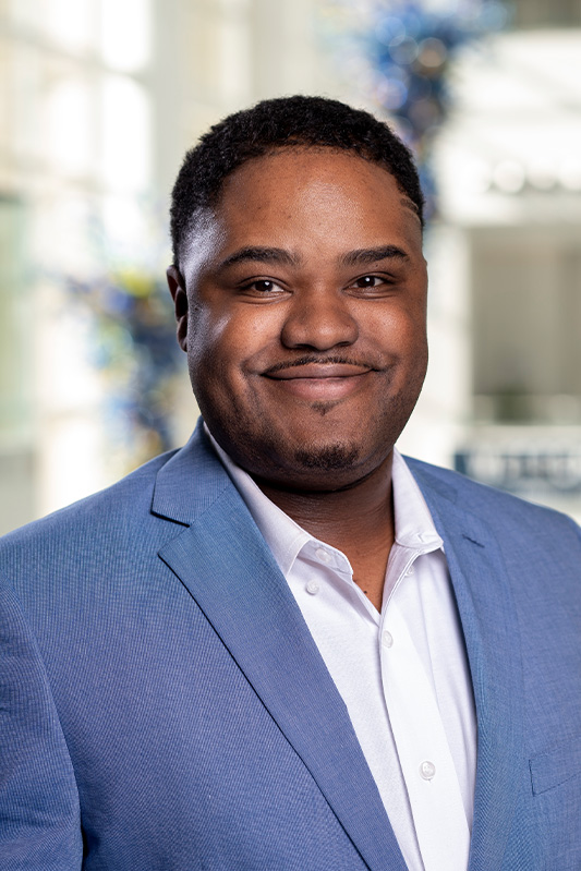 Jacoby Golden, Evening MBA '23 in a blue business suit