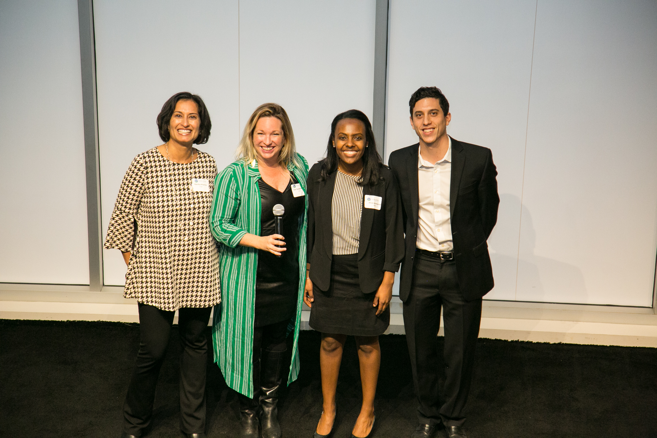 Global Finalist team, NeMo (Johns Hopkins), on stage with judges Ayesha Khanna (Points of Light) and Dar Vanderbeck (CARE)