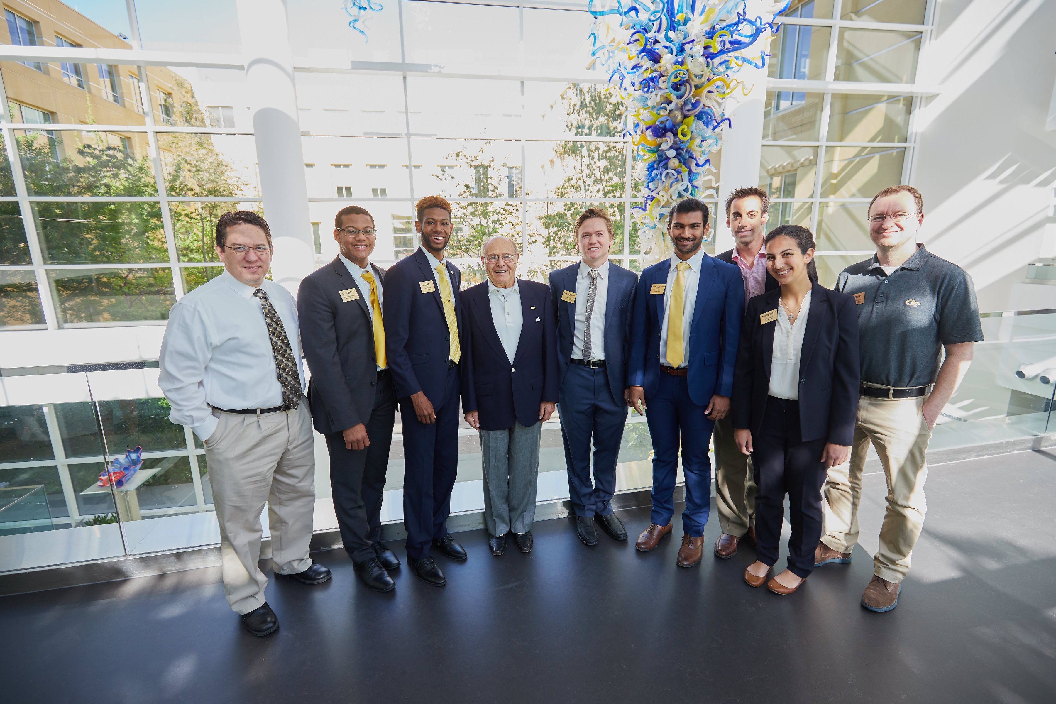 Ernest Scheller, Jr. meets the Caterpillar T&M team after their presentation.