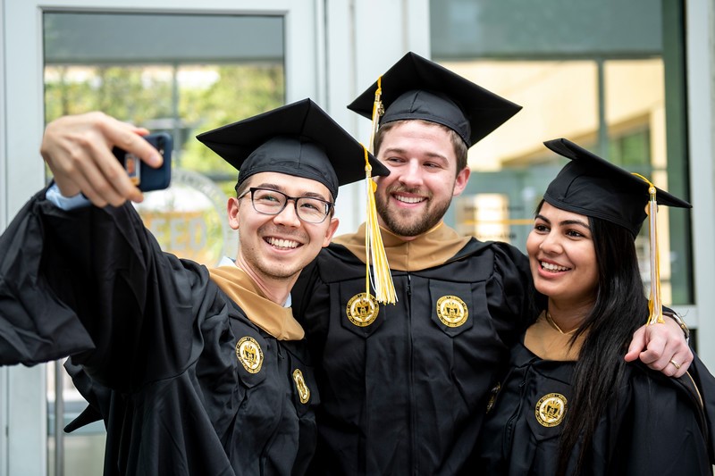 Full-time MBA students celebrate their commencement with a selfie.