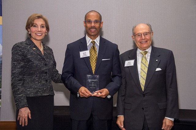 Dean Maryam Alavi (left) and Ernest Scheller, Jr. (right) award Kevin Stacia (center) with the Ernest Scheller, Jr. Prize.