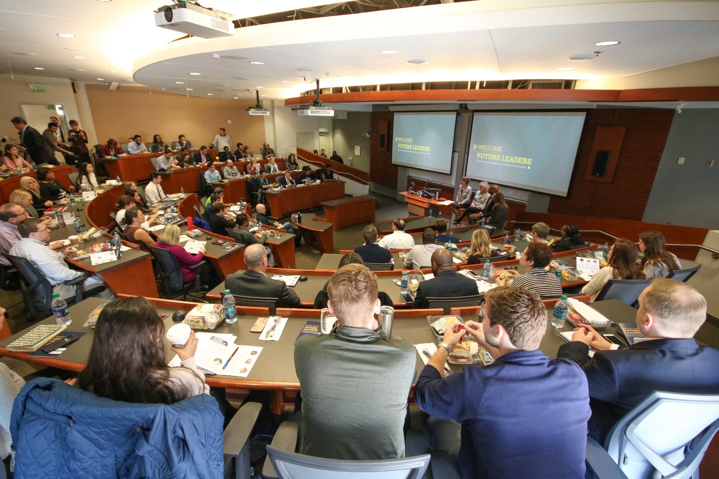 A packed room listens in on the panel discussion.