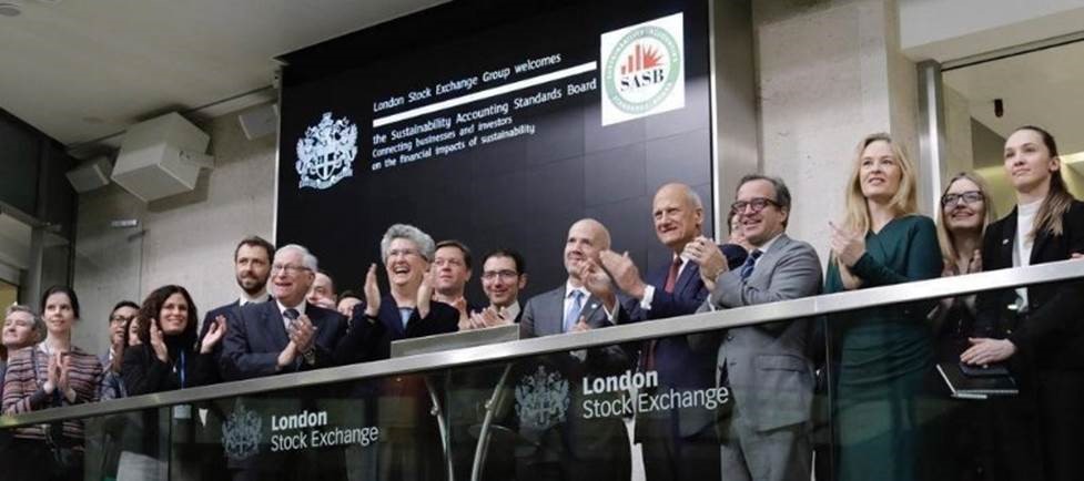 Jeffrey Hales (center) and members of the Sustainability Accounting Standards Board ring the opening bell at the London Stock Exchange.