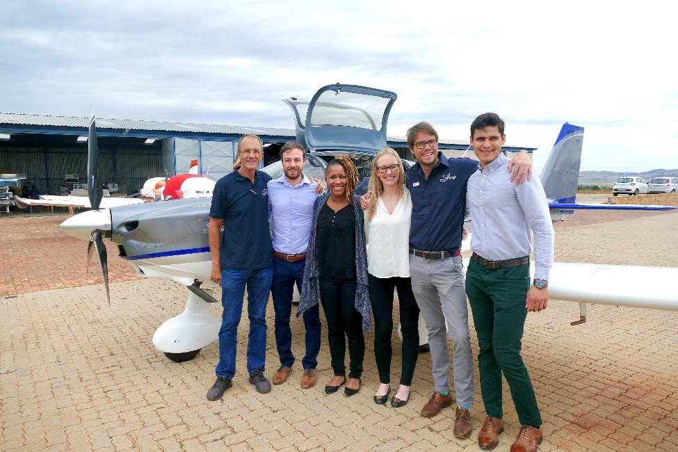 MBA students pose with their client sponsors from The Airplane Factory in South Africa.