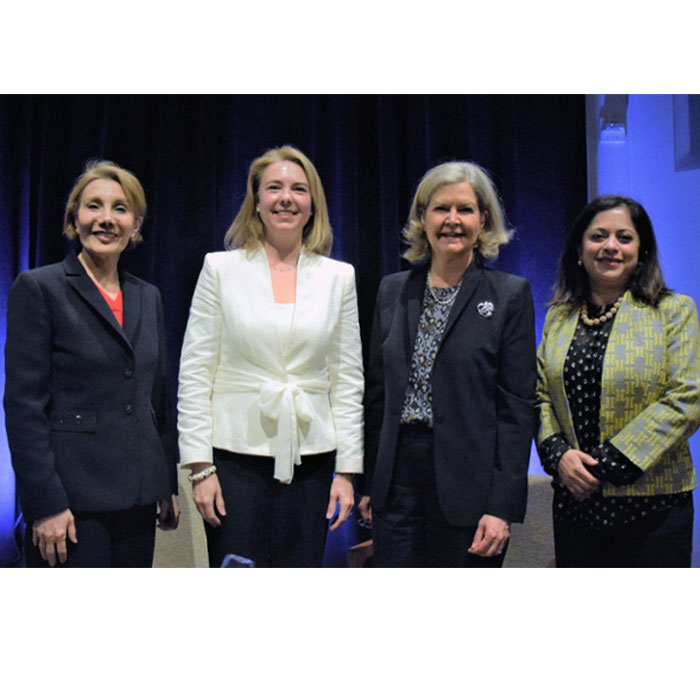 Four women standing on stage