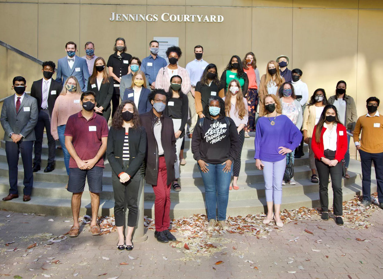A group photo of Scheller students outside on steps in a courtyard.