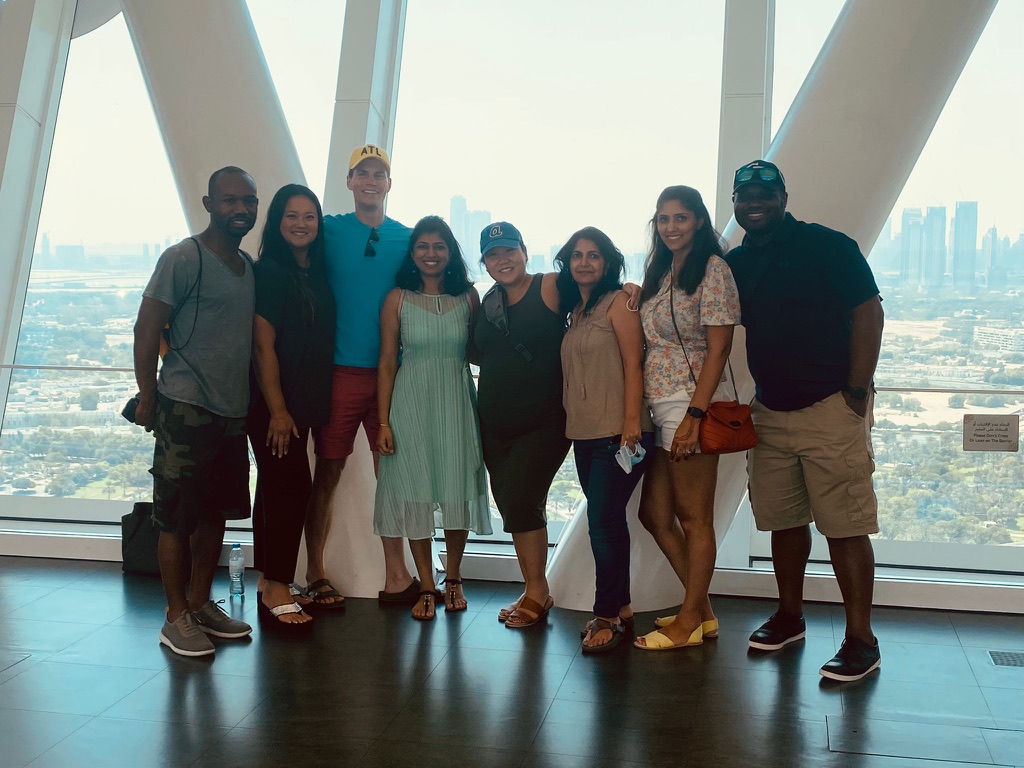 A group of student standing in front of a window