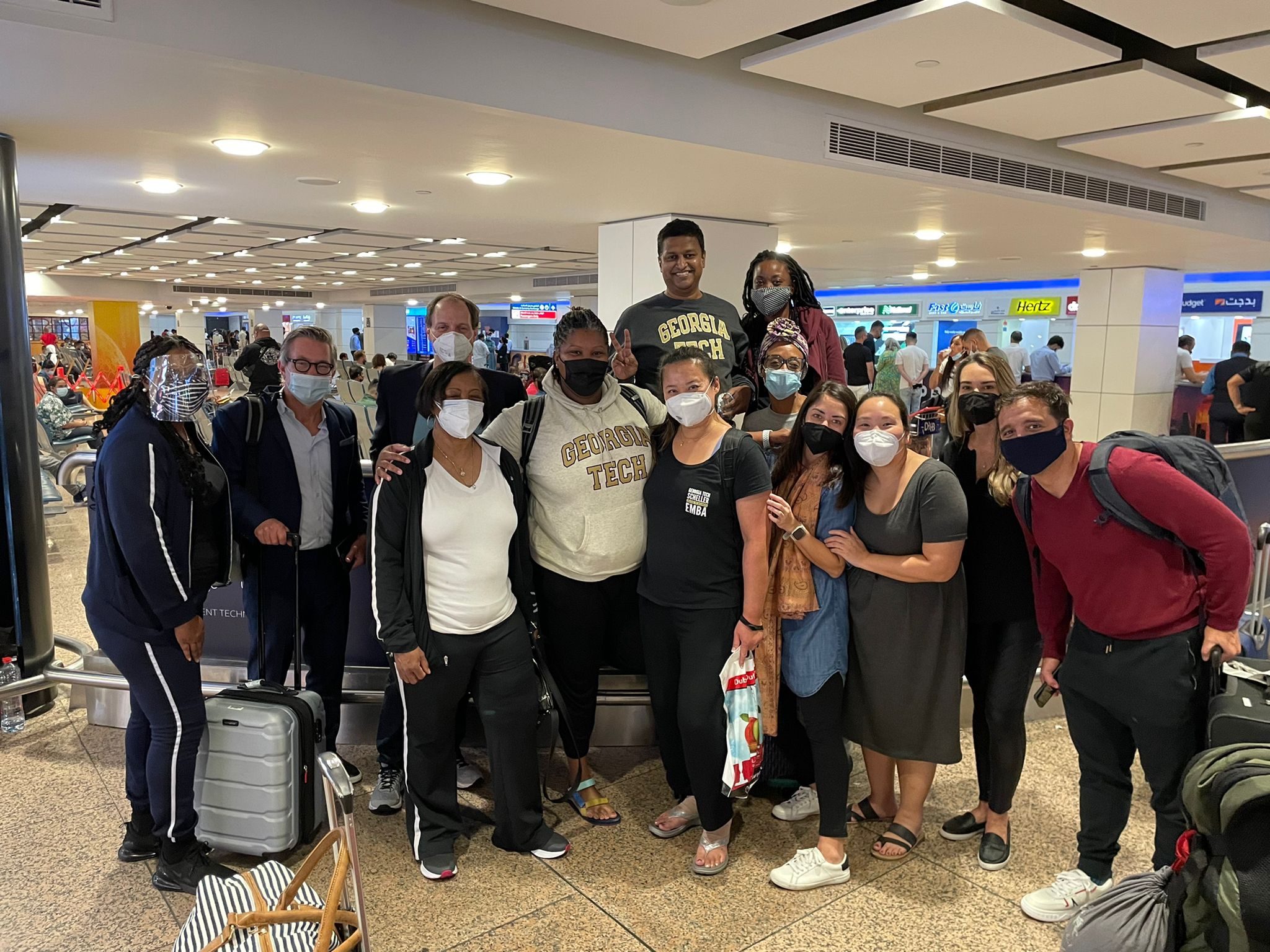 A group of Scheller students stand in the airport