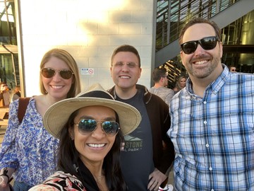 A group of four students standing outside 