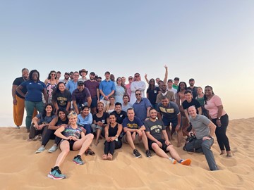 A group of students on a sand dune