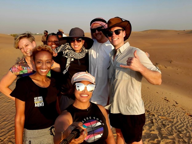 A group of students standing on the sand dunes in Dubai