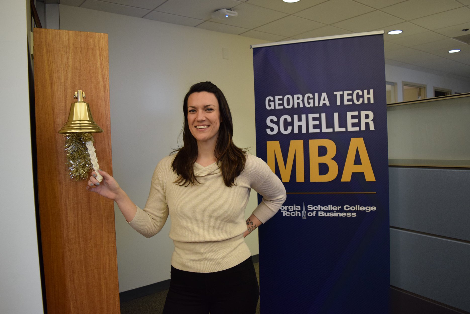 MBA student Nona Black rings a bell in the MBA Jones Career Center