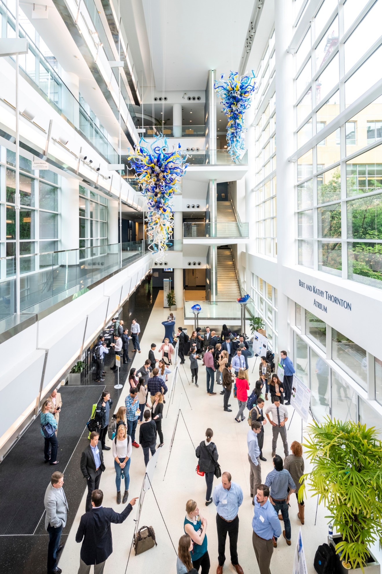 Scheller college's atrium with people networking with each other.