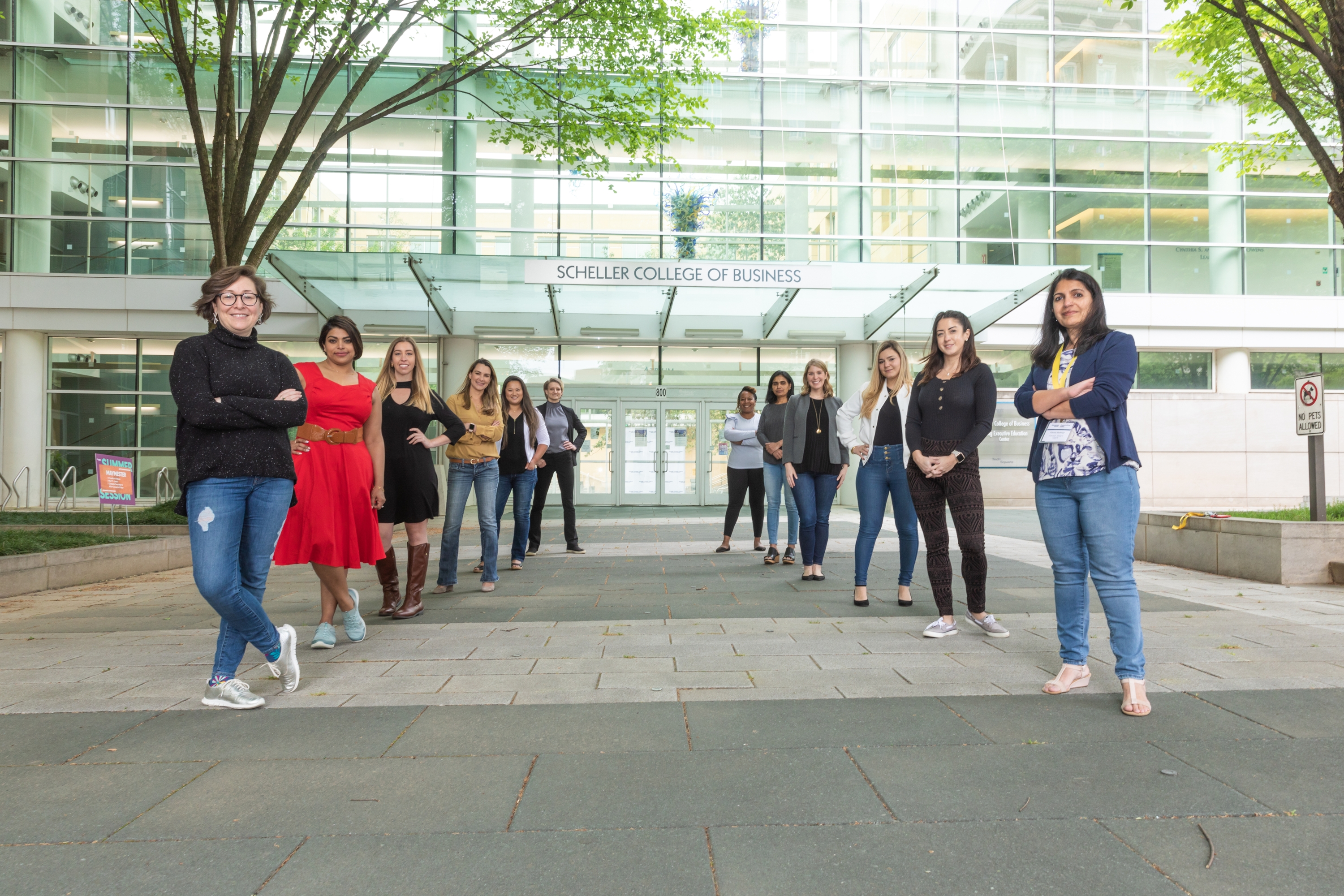 A group of women standing outside the entry to the Scheller College of Business.