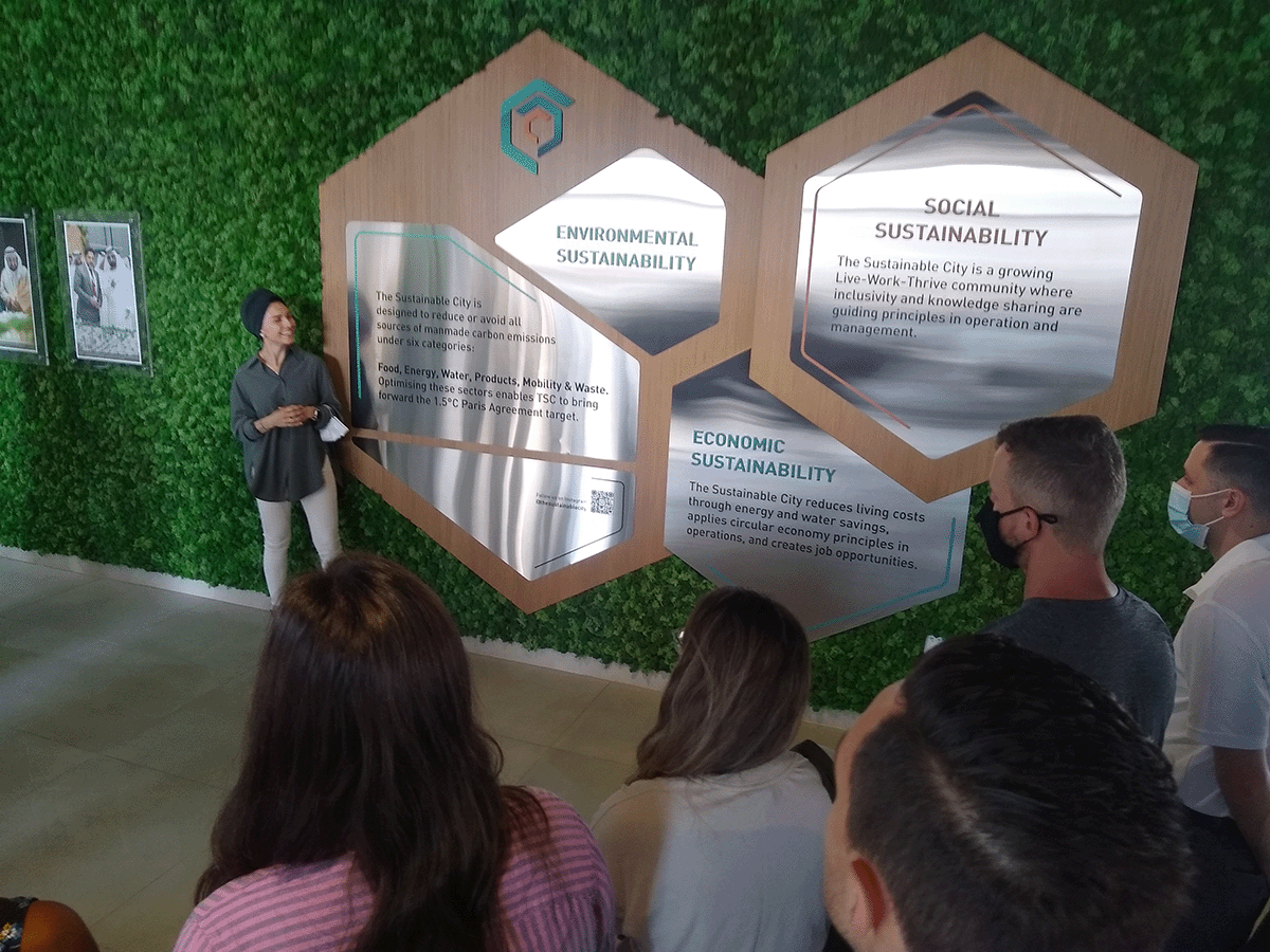 A women stands in front of signs