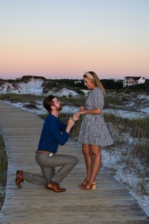 A man down on one knee proposing marriage to a woman. 