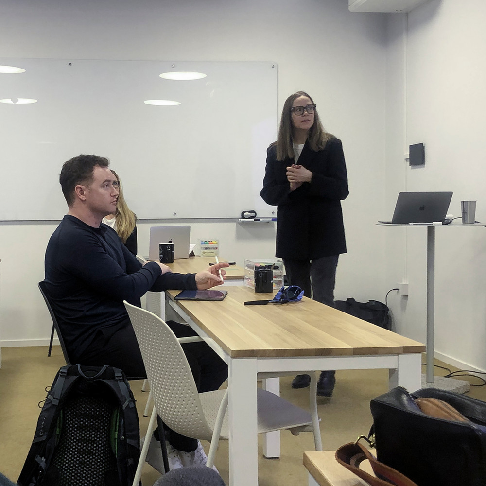 A women addresses students in a classroom