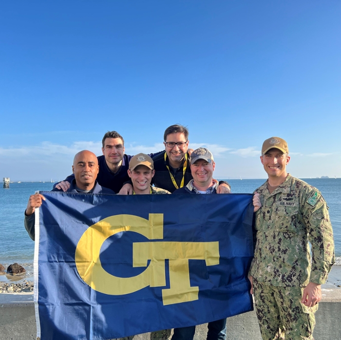 Left to right: Stephen Ruffin (AE), Juergen Rauleder (AE), Lt. Jacob Rothstein of the U.S. Navy, Julian Rimoli (AE), John Stanford (Denning T&M), Commander Ken Kirkwood of the U.S. Navy
