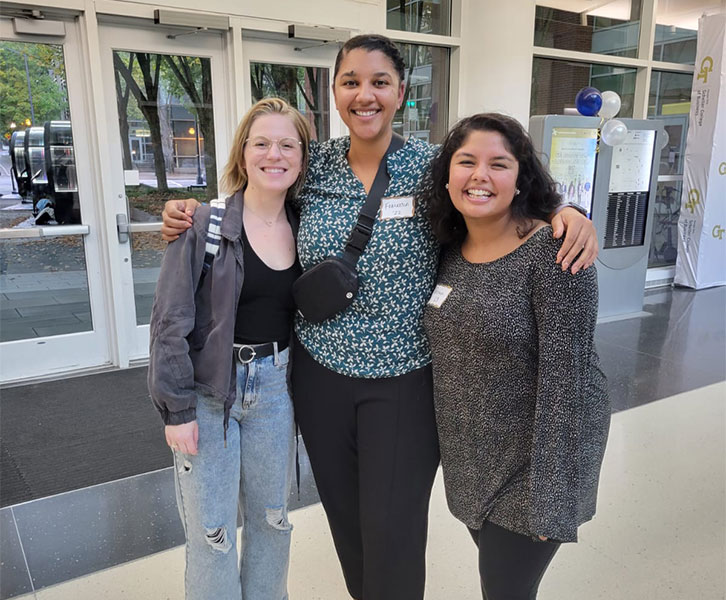 Three Full-time women MBAs stand outside the Scheller building   