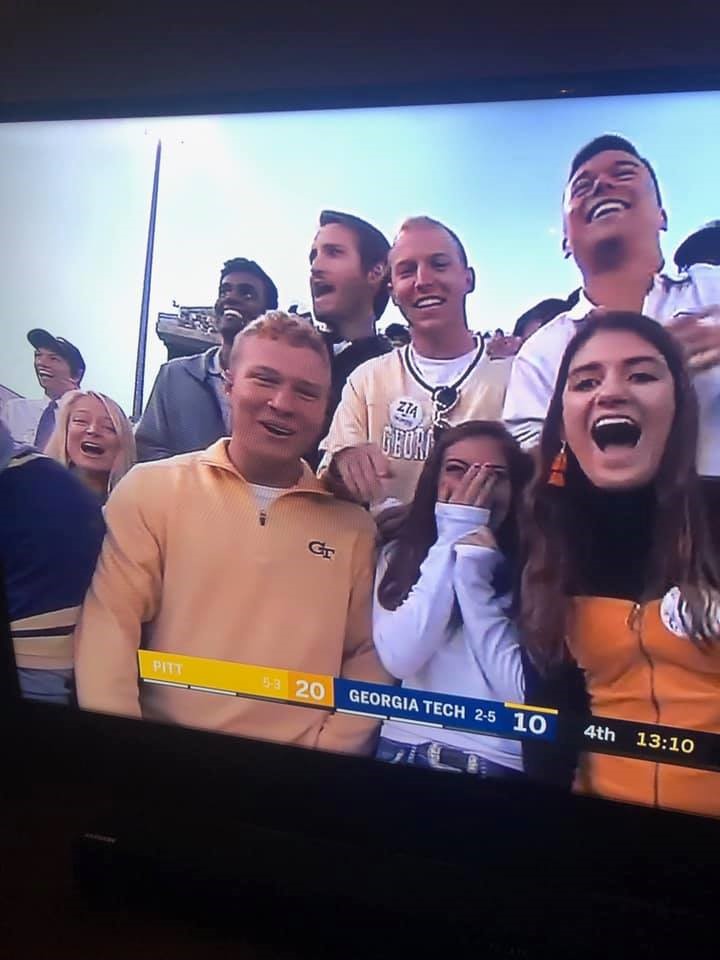 A picture of students cheering at a football game