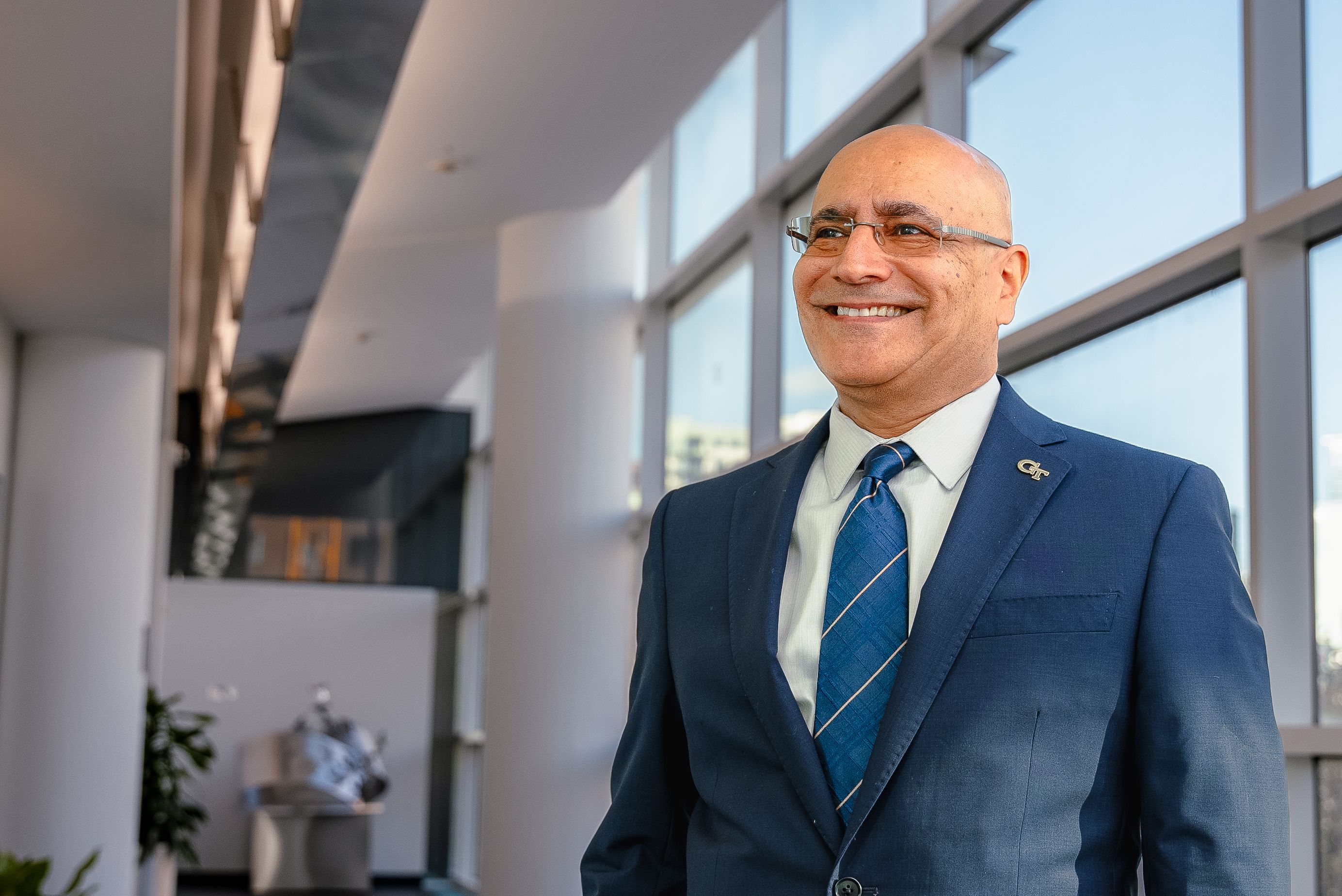 Dean-Elect Anuj Mehrotra smiling in the Scheller building 