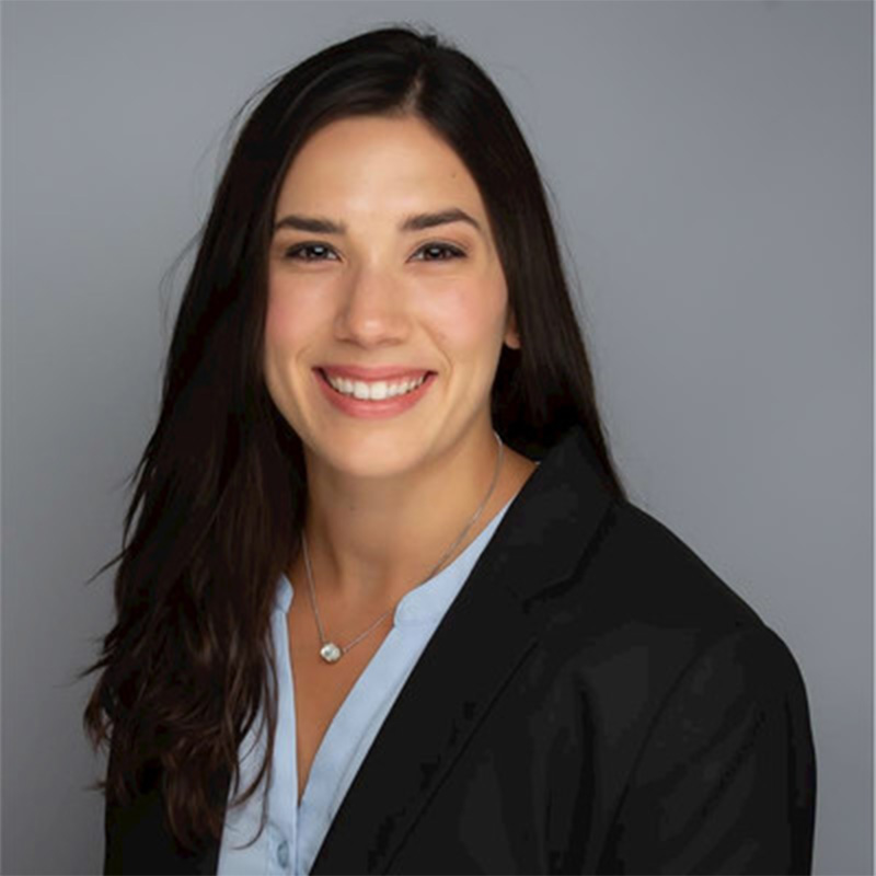 Cristina Striker, Evening MBA ’25 and engineer at Stryker, smiles in a blue shirt and black business jacket 