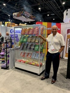 Haywood Solomon standing beside a display case