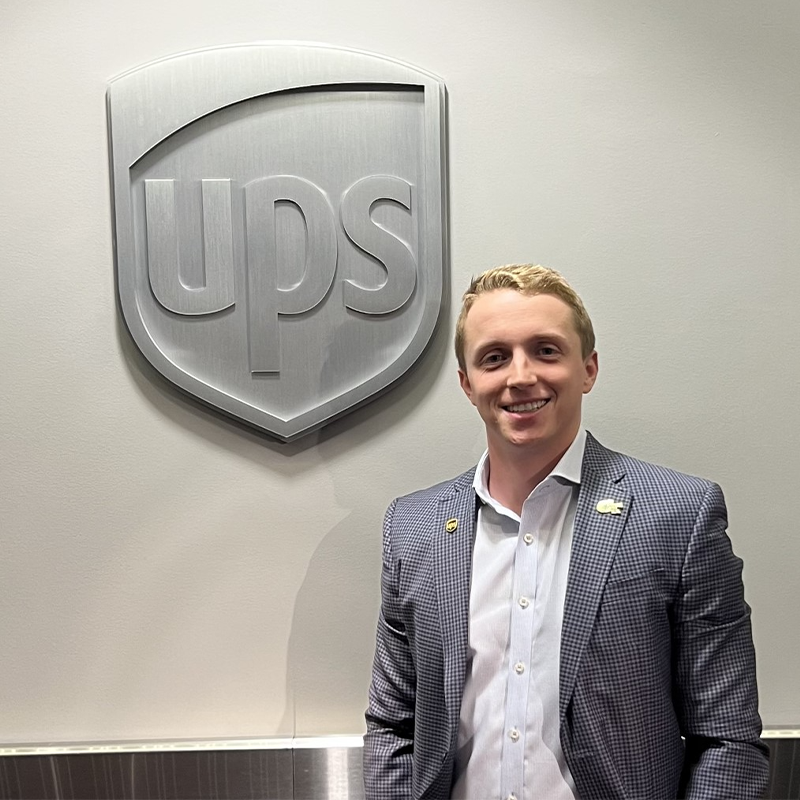 Justin Jones, Executive MBA ‘23, stands in front of a UPS sign