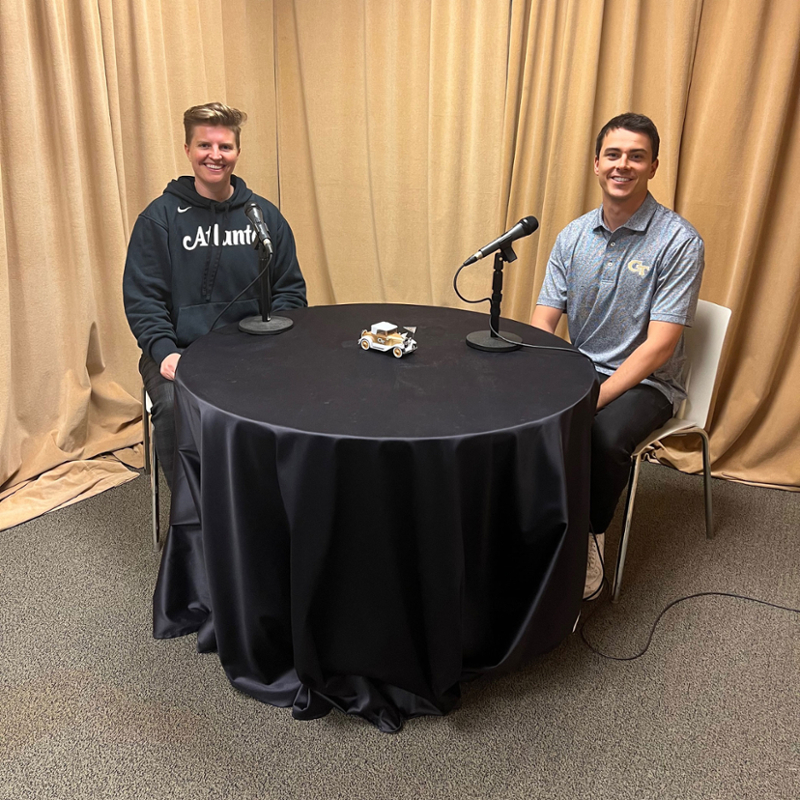 Full time MBA student Leo Haigh and Natalie Hendricks, Evening MBA student and Director of Content for the Atlanta Hawks, sit around a table to record a podcast