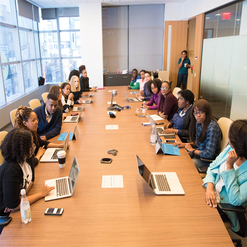 Group of workers around a long square table