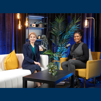 Two women sitting in a room with microphones