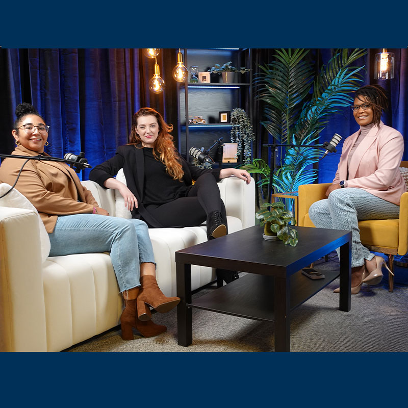 Three Scheller MBA women sit next to each other with microphones. 