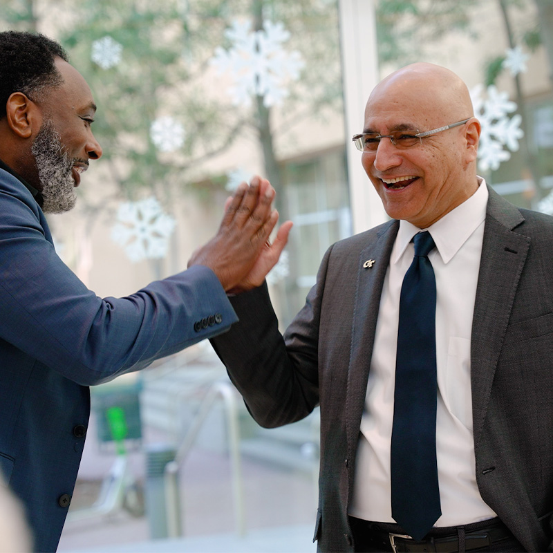 Dean Anuj Mehrotra greets faculty and staff at the Scheller College of Business